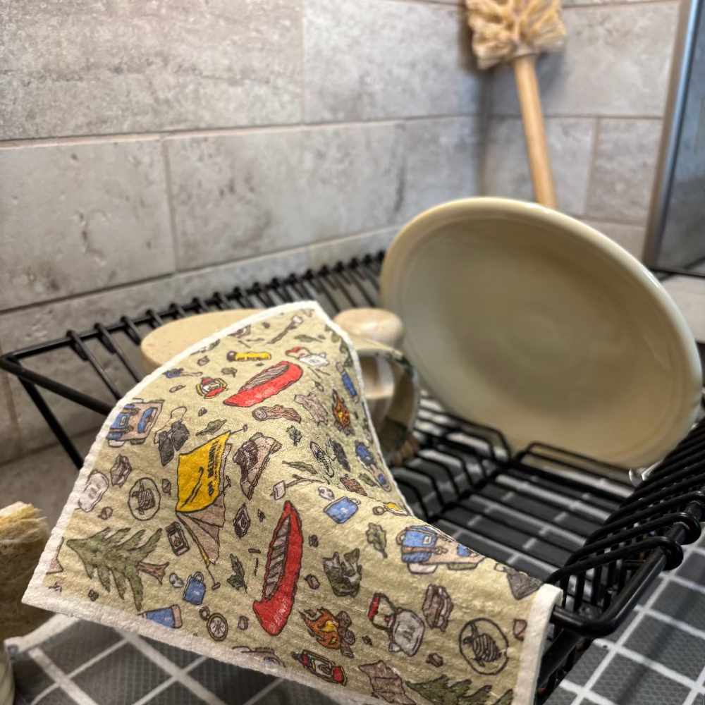 Patterned dish towel on a dish rack with a tiled kitchen background